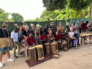 Liz Jackson performing percussion music with local villagers